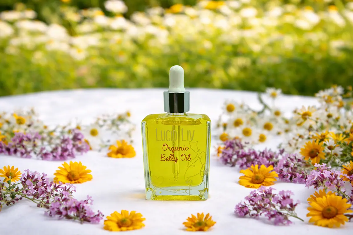 Lucid Liv Organic Belly Oil surrounded by daisies and wildflowers